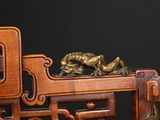 a wooden chair with a dragon on the back of it