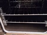 an open oven with a lot of racks inside of it