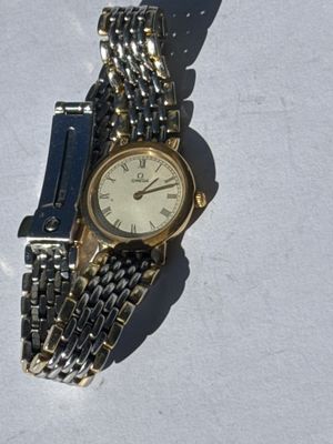 a watch that is laying on a white surface