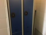 deux casiers bleus dans une salle de bains, à côté des toilettes