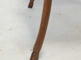 an old wooden table with a glass top on a white floor