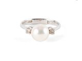 gros plan d'une bague en perles et diamants sur fond blanc