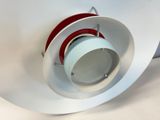 a red and white object in the middle of a circular object