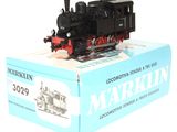 a box with a toy train on it on a white surface