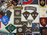 a lot of patches and badges on a table