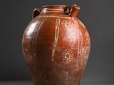 a brown vase that is sitting on a table