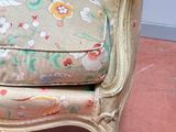 a chair with a floral upholstered cushion on it