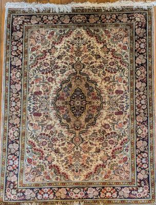 an antique persian rug on a wooden floor
