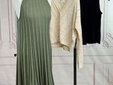 two women ' s dresses hanging on a rack in front of a wall