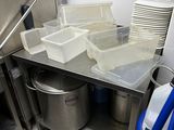 a kitchen with a lot of dishes and containers on the counter