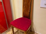 a red chair in the corner of a room