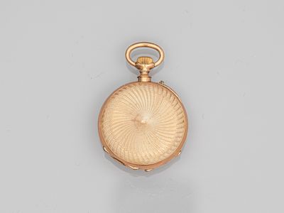 an old gold pocket watch with a chain hanging from it ' s side