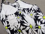 a black and white dress with yellow flowers on it