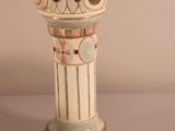 a white vase with a design on it on a table