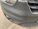 a close up of the front of a car with a denting bumper