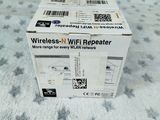 a box of wireless wifi repeater sitting on a bed