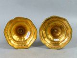 pair of golden vases on a white background with a label on the bottom