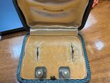 an open case with two pairs of earrings inside of it