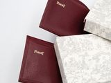 three books are stacked on top of each other on a white surface