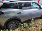 a silver car that is parked on the side of the road