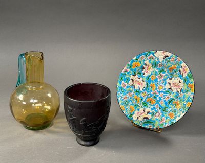 two vases and a plate sitting next to each other