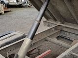 an image of a dump truck with a large pipe sticking out of it ' s side