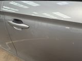 the door of a car with a sticker on the side of it