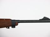 a close up of a rifle with a wooden barrel on a white background