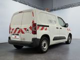 a white van with red and white stripes parked in a garage