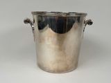 a silver ice bucket with handles on a white table
