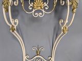 a table with a marble top and gold decorations on it
