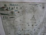a map on the wall of a room with pictures on it