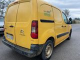 a yellow van that is parked in a parking lot