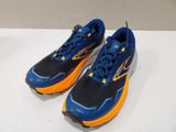 a pair of blue and orange shoes sitting on top of a white table