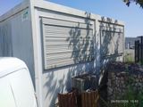 a white van parked next to a building with shutters on it