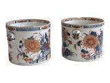 pair of chinese vases with floral designs on them on a white background