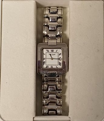 wrist watch in a box on a white surface with a white background