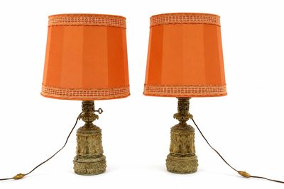 pair of orange lamps sitting on top of each other on a white surface