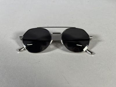sunglasses on a white table with a white background