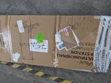 a cardboard box on the ground with stickers on it