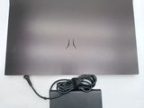 a silver laptop with a power cord attached to it