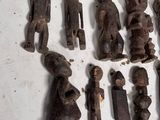 a lot of wooden figurines that are on a table