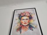 painting of a woman with a flower in her hair hanging on a wall