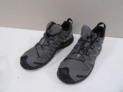 pair of gray and black shoes on a white surface