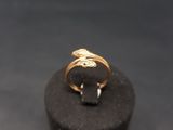 a close up of a gold ring on top of a black box