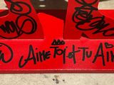 a red tray with a pair of red shoes on it