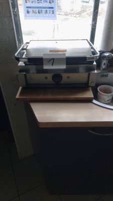 a coffee maker sitting on top of a counter next to a window