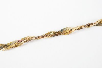 a close up of a gold chain with small beads on it