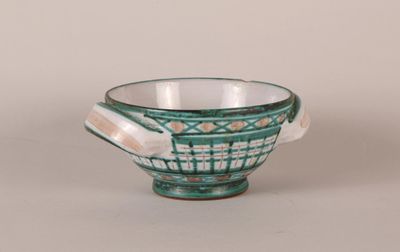 an image of a green and white bowl sitting on a table