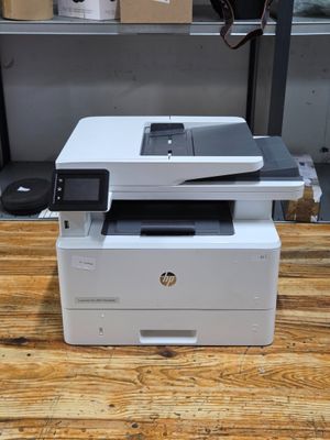 a white printer sitting on top of a wooden table